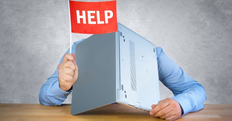 Person holding a laptop while raising a red flag with the word 'HELP'